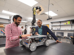 Texas Engineer Maruthi Akella and graduate student working on aerospace machinery in his lab.